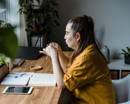Person sitting quietly with a cup of tea