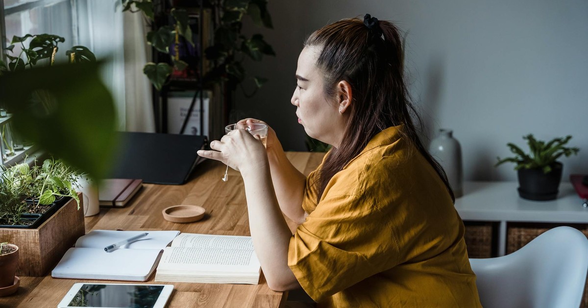 Person sitting quietly with a cup of tea