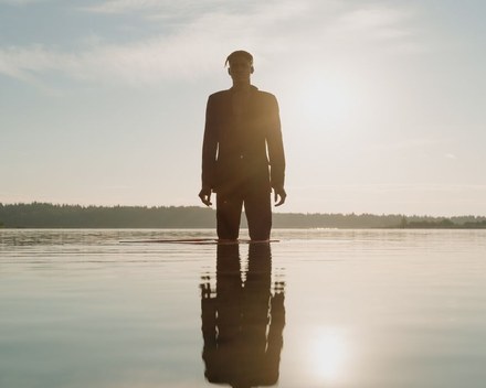 Person standing quietly in soft natural light